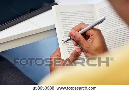 University student writing notes in book View Large Photo Image Stock Photo - University student writing notes in book. Fotosearch