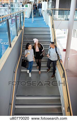 Stock Image - University students going down stairs. Fotosearch