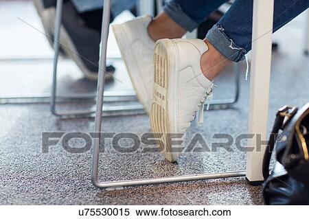 Stock Photography - University students in class, view of feet. Fotosearch