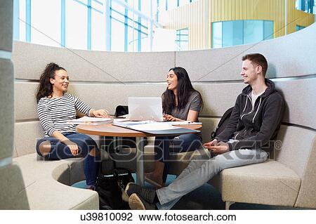 University students relaxing in modern seating area View Large Photo Image Stock Image - University students relaxing in modern seating area. Fotosearch