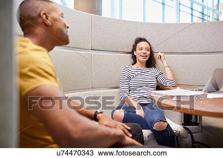 University students relaxing in modern seating area View Large Photo Image Stock Image - University students relaxing in modern seating area. Fotosearch