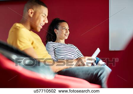 Stock Image - University students relaxing. Fotosearch