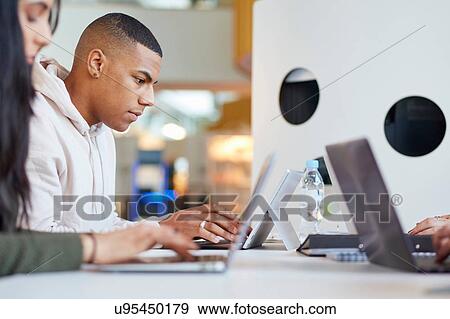 University students using laptops and digital tablet, working together View Large Photo Image Stock Photo - University students using laptops and digital tablet, working together. Fotosearch