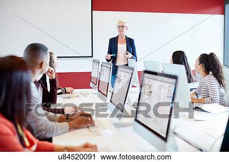 Stock Image - University students working at computer in class. Fotosearch
