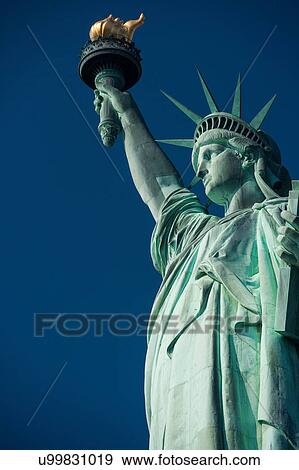View of the Statue of Liberty against blue sky, New York, USA View Large Photo Image Stock Photo - View of the Statue of Liberty against blue sky, New York, USA. Fotosearch