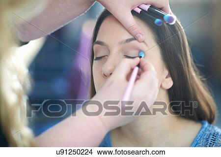 Woman applying make-up to young woman View Large Photo Image Picture - Woman applying make-up to young woman. Fotosearch