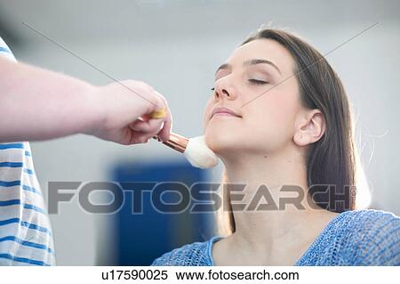 Woman applying make-up to young woman View Large Photo Image Stock Photography - Woman applying make-up to young woman. Fotosearch