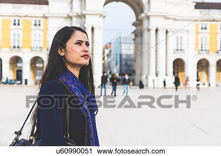 Stock Image - Woman at Praca Do Comercio looking away, Lisbon, Portugal. Fotosearch