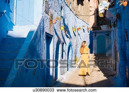 Stock Image - Woman exploring, Chefchaouen, Morocco, North Africa. Fotosearch