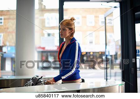 Stock Photo - Woman going through security barrier on arrival at work. Fotosearch