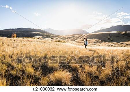 Stock Image - Woman hiking, Trans Canada Highway, near Kamloops, Boston Flats, British Columbia, Canada. Fotosearch