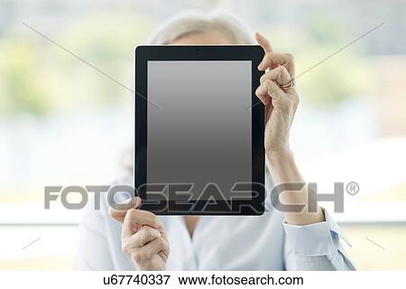 Woman holding digital tablet View Large Photo Image Stock Photo - Woman holding digital tablet. Fotosearch