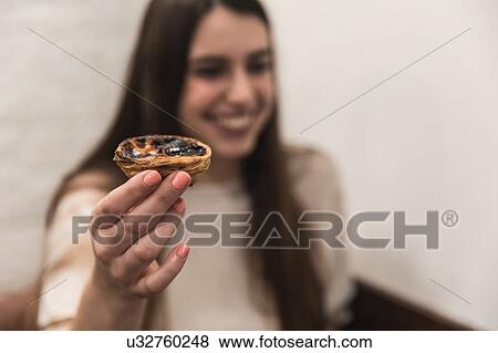 Woman holding pastry smiling View Large Photo Image Stock Photo - Woman holding pastry smiling. Fotosearch