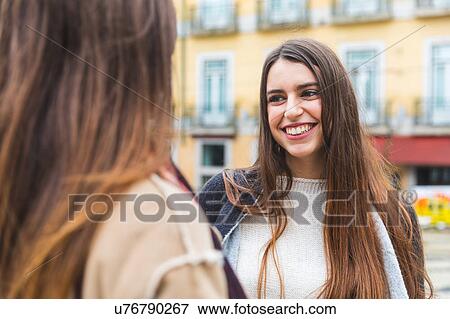 Woman looking at friend smiling View Large Photo Image Stock Photo - Woman looking at friend smiling. Fotosearch