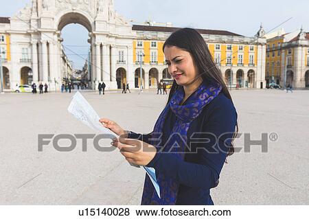 Stock Photo - Woman looking at map, Praca Do Comercio, Lisbon, Portugal. Fotosearch