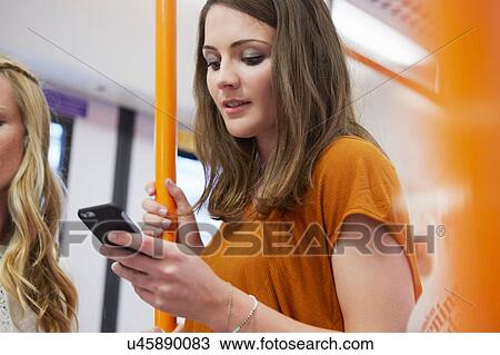 Woman reading on tube, London, UK View Large Photo Image Stock Image - Woman reading on tube, London, UK. Fotosearch
