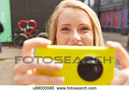 Woman taking selfie in street, London, UK View Large Photo Image Stock Image - Woman taking selfie in street, London, UK. Fotosearch