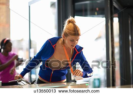 Woman tapping on security barrier on arrival at work View Large Photo Image Stock Image - Woman tapping on security barrier on arrival at work. Fotosearch
