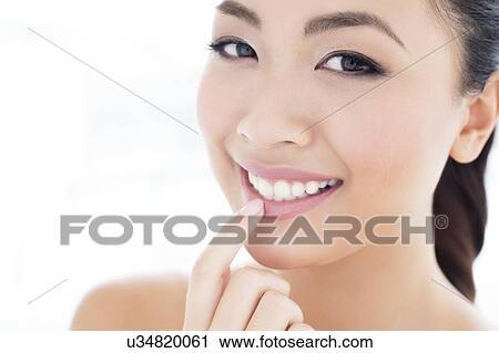 Woman touching lip View Large Photo Image Stock Image - Woman touching lip. Fotosearch
