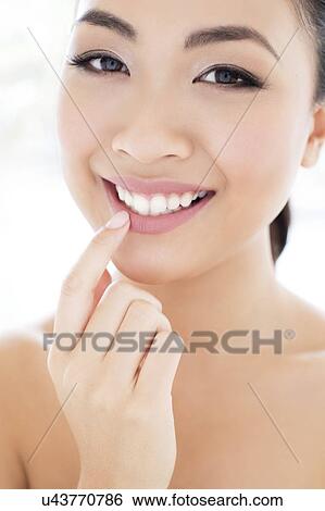 Woman touching lip View Large Photo Image Stock Photograph - Woman touching lip. Fotosearch