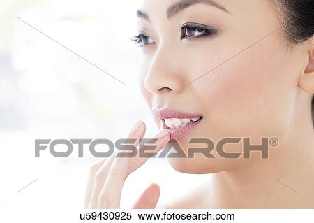 Woman touching lip View Large Photo Image Stock Photography - Woman touching lip. Fotosearch