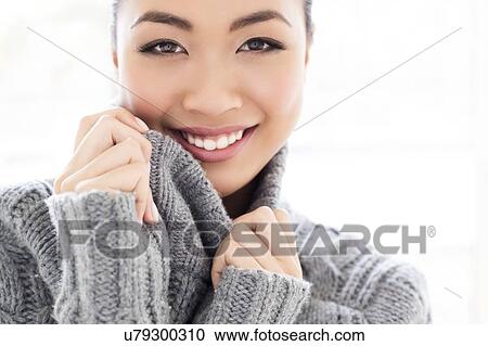 Stock Image - Woman wearing grey knitted sweater. Fotosearch