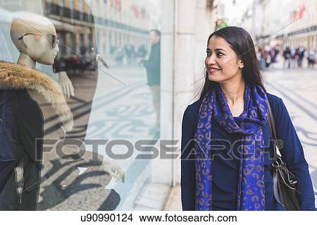 Picture - Woman window shopping, Lisbon, Portugal. Fotosearch