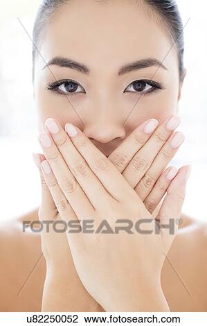 Woman with hands touching covering mouth View Large Photo Image Stock Image - Woman with hands touching covering mouth. Fotosearch
