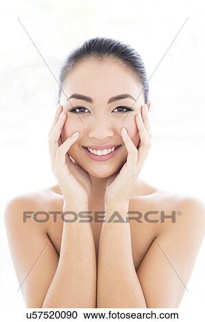Woman with hands touching face View Large Photo Image Stock Image - Woman with hands touching face. Fotosearch