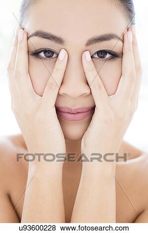 Woman with hands touching face View Large Photo Image Stock Photo - Woman with hands touching face. Fotosearch