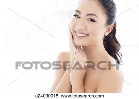 Woman with hands touching face View Large Photo Image Stock Photography - Woman with hands touching face. Fotosearch
