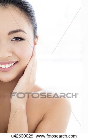 Woman with hands touching face View Large Photo Image Stock Photography - Woman with hands touching face. Fotosearch