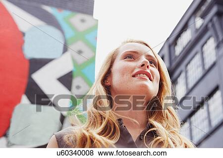 Women smiling, wall art in background, London, UK View Large Photo Image Stock Photo - Women smiling, wall art in background, London, UK. Fotosearch