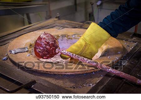 Worker holding red hot stirrer above molten aluminium in precision casting factory, close up View Large Photo Image Stock Image - Worker holding red hot stirrer above molten aluminium in precision casting factory, close up. Fotosearch