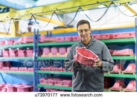 Worker holding wax component in precision casting factory View Large Photo Image Stock Photo - Worker holding wax component in precision casting factory. Fotosearch