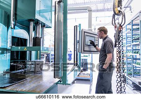 Worker making wax component in a press in precision casting factory View Large Photo Image Stock Photograph - Worker making wax component in a press in precision casting factory. Fotosearch