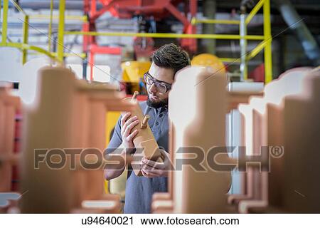 Worker preparing component in precision casting factory View Large Photo Image Stock Image - Worker preparing component in precision casting factory. Fotosearch