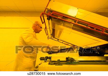 Worker screen printing circuit board in safe yellow light in electronics factory View Large Photo Image Stock Photography - Worker screen printing circuit board in safe yellow light in electronics factory. Fotosearch