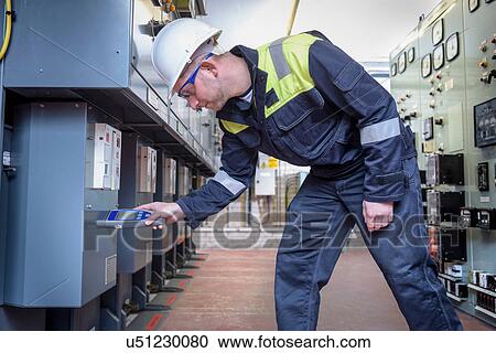 Worker testing for noise in electricity substation View Large Photo Image Stock Image - Worker testing for noise in electricity substation. Fotosearch
