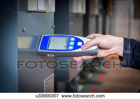 Stock Photo - Worker testing for noise in electricity substation. Fotosearch