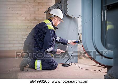 Stock Photography - Worker testing transformers in electricity substation. Fotosearch