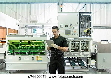 Worker using digital tablet with circuit board processing machine in electronics factory View Large Photo Image Stock Photograph - Worker using digital tablet with circuit board processing machine in electronics factory. Fotosearch