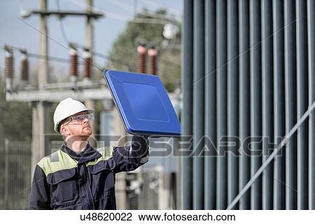 Worker using partial discharge detector in electricity substation View Large Photo Image Stock Image - Worker using partial discharge detector in electricity substation. Fotosearch