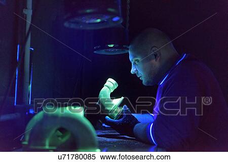 Worker using ultra-violet light to test for cracks in components in precision casting factory View Large Photo Image Stock Photography - Worker using ultra-violet light to test for cracks in components in precision casting factory. Fotosearch