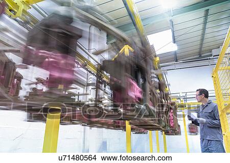 Picture - Worker with wax moulded components in precision casting factory. Fotosearch