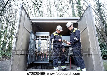 Workers checking and testing electricity substation View Large Photo Image Stock Photo - Workers checking and testing electricity substation. Fotosearch