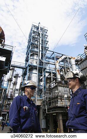 Workers on oil refinery View Large Photo Image Stock Image - Workers on oil refinery. Fotosearch