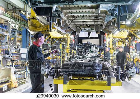 Workers on production line in car factory View Large Photo Image Stock Image - Workers on production line in car factory. Fotosearch