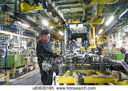 Stock Photography - Workers on production line in car factory. Fotosearch