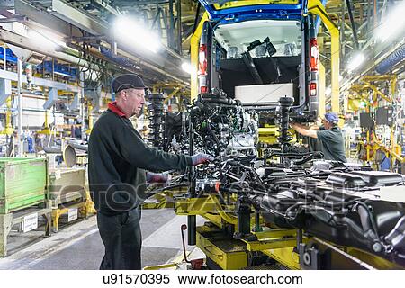 Stock Photography - Workers on production line in car factory. Fotosearch